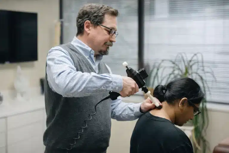 Dr. David Mayes performing a precision, non-manual adjustment using the ArthroStim instrument at Bellevue Chiropractic