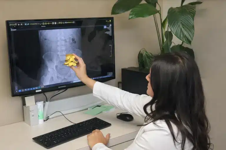 Dr. Diba Naweed educating patient on their X-rays and discussing treatment plan with the patient at Bellevue Chiropractic