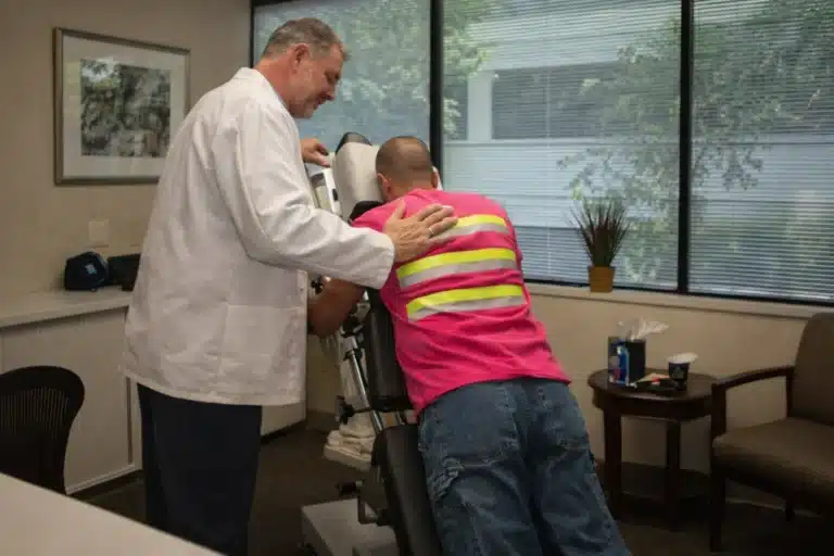 Patient receiving spinal decompression therapy on a specialized table at Bellevue Chiropractic to restore mobility
